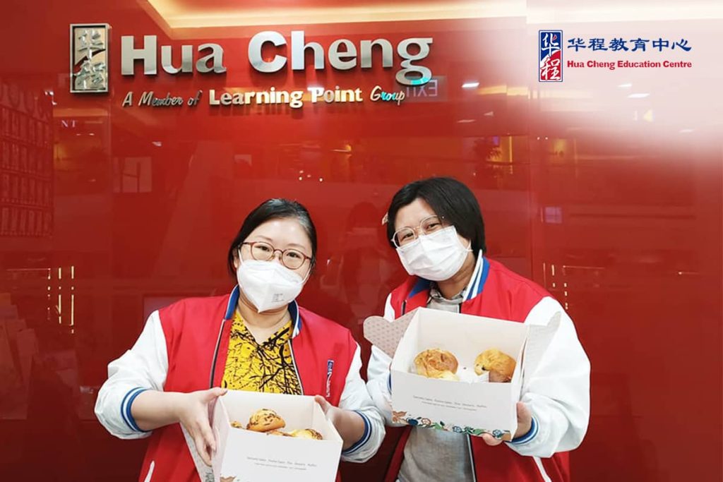 Staff holding baked goods at Hua Cheng Education Centre Singapore