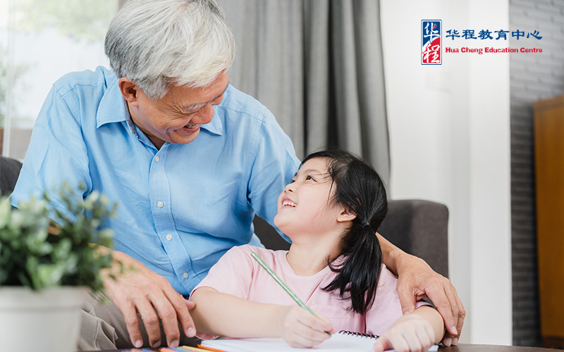 Asian Grandfather Homeschooling His Granddaughter