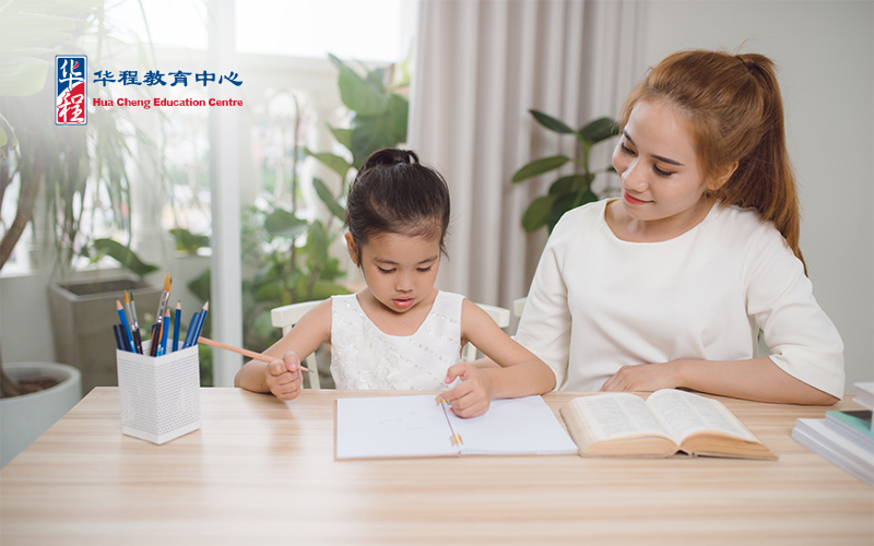 mother helping her daughter study